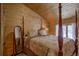 Cozy bedroom with a wooden post bed and mountain views at 229 Lee Ln, Breckenridge, CO 80424