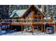 Log home exterior with large deck, snowy landscape, and mountain views at 229 Lee Ln, Breckenridge, CO 80424