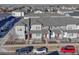 Aerial view of townhouses with attached garages and parking at 16023 E Warner Pl, Denver, CO 80239