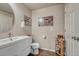 Small bathroom with white vanity, toilet and wood-look flooring at 16023 E Warner Pl, Denver, CO 80239