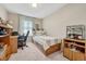 Well-lit bedroom with a twin bed and home office space at 16023 E Warner Pl, Denver, CO 80239