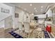 Bright dining area with table and chairs, open to kitchen at 16023 E Warner Pl, Denver, CO 80239