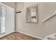 Bright entryway with wood floor, mirror, and coat hooks at 16023 E Warner Pl, Denver, CO 80239