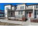 Modern townhome exterior with gray siding and red door at 16023 E Warner Pl, Denver, CO 80239