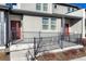 Townhome entrance with red door and metal railing at 16023 E Warner Pl, Denver, CO 80239