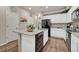 Modern kitchen island with granite countertops and stainless steel appliances at 16023 E Warner Pl, Denver, CO 80239