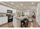 Open concept kitchen with island, granite countertops, and stainless steel appliances at 16023 E Warner Pl, Denver, CO 80239