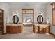 Double vanity bathroom with a view into the bedroom at 556 S Manila Rd, Bennett, CO 80102