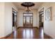 Elegant entryway with hardwood floors, ornate door, and chandelier at 556 S Manila Rd, Bennett, CO 80102