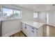 The kitchen has a bright window, a lot of storage, and a quartz countertop at 2830 E 99Th Way, Thornton, CO 80229