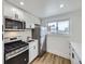 Modern kitchen with stainless steel appliances and white cabinets, providing a stylish and efficient cooking space at 2830 E 99Th Way, Thornton, CO 80229