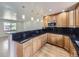 Spacious kitchen with wood cabinets, black countertops, and stainless steel appliances at 2830 E 99Th Way, Thornton, CO 80229