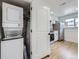 Modern laundry setup with in-unit washer and dryer, as well as white cabinets at 2830 E 99Th Way, Thornton, CO 80229