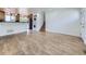 Bright and open living room with hardwood floors adjoining the kitchen and stair access at 2830 E 99Th Way, Thornton, CO 80229