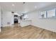 Inviting living space with a sleek kitchenette, featuring updated appliances and ample natural light, perfect for modern living at 2830 E 99Th Way, Thornton, CO 80229
