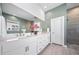 Bright bathroom featuring dual sinks and a large mirror at 5925 La Posada Pl, Parker, CO 80134