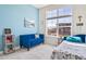 Bright bedroom featuring a comfortable blue sofa and a large window overlooking the neighborhood at 5925 La Posada Pl, Parker, CO 80134