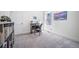 Clean bedroom featuring a desk, gray chair, and bookshelf for storage at 5925 La Posada Pl, Parker, CO 80134