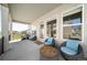 Relaxing covered patio with a lounge chair and table setting, great for outdoor living at 5925 La Posada Pl, Parker, CO 80134