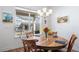 Cozy dining area with a wooden table, comfortable seating, and natural light from the window at 5925 La Posada Pl, Parker, CO 80134