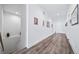 Hallway boasts hardwood floors and neutral decor, with stairway and a picture gallery at 5925 La Posada Pl, Parker, CO 80134