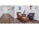 Hallway with rich wood-look flooring, white trim, and a collection of decorative artwork at 5925 La Posada Pl, Parker, CO 80134