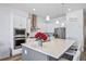 Modern kitchen with white cabinets, stainless steel appliances, and a gray kitchen island at 5925 La Posada Pl, Parker, CO 80134