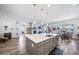 Expansive island kitchen with stainless appliances, pendant lights, and an open layout at 5925 La Posada Pl, Parker, CO 80134