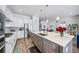 Modern kitchen with stainless appliances, large island, and open floor plan to living areas at 5925 La Posada Pl, Parker, CO 80134