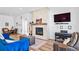 Cozy living space with fireplace, bookshelf, and entertainment setup at 5925 La Posada Pl, Parker, CO 80134