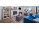 Cozy living room with fireplace, bookshelf, flat-screen TV, and comfortable seating at 5925 La Posada Pl, Parker, CO 80134