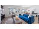 Inviting living room featuring a comfortable blue sofa and large windows at 5925 La Posada Pl, Parker, CO 80134