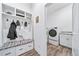 Functional mudroom with built-in storage and bench seating, adjacent to the laundry area at 5925 La Posada Pl, Parker, CO 80134