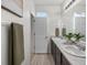 Long bathroom featuring a double sink vanity with decorative plants and a gray towel at 5347 Warrior St, Frederick, CO 80504