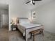 Bedroom featuring a bed, nightstands with lamps, a window, and a wood bench at 5347 Warrior St, Frederick, CO 80504