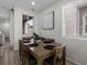 Dining room with a wood table, matching chairs, and natural light from a window at 5347 Warrior St, Frederick, CO 80504