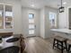 Bright dining area featuring light wood floors, a front door and an open floor plan at 5347 Warrior St, Frederick, CO 80504