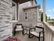 Cozy front porch with seating, offering a relaxing outdoor space with stone accents at 5347 Warrior St, Frederick, CO 80504