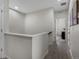 Upstairs hallway leading to doorways. Neutral walls, wood-look floors, and natural light at 5347 Warrior St, Frederick, CO 80504