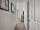 Hallway with neutral walls, carpet, and artwork leading to other rooms in the house at 5347 Warrior St, Frederick, CO 80504
