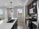 Modern kitchen with stainless steel appliances, white countertops and an island with seating at 5347 Warrior St, Frederick, CO 80504