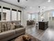 Open-concept living area with a modern kitchen and dining space adjacent to the bright living room at 5347 Warrior St, Frederick, CO 80504