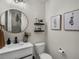 Tastefully decorated powder room with a modern sink, fixtures, and decorative wall art at 5347 Warrior St, Frederick, CO 80504