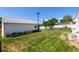 Spacious backyard featuring a well-maintained lawn, garden area, privacy fence, and detached garage at 1748 W Tennessee Ave, Denver, CO 80223