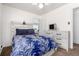 Inviting bedroom features a rustic bed, neutral walls, and plenty of natural light at 1748 W Tennessee Ave, Denver, CO 80223