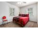 Charming bedroom featuring light walls, dual windows, and a cozy bed at 1748 W Tennessee Ave, Denver, CO 80223