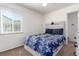 Bright bedroom featuring a cozy bed with storage, soft lighting, and a soothing color scheme at 1748 W Tennessee Ave, Denver, CO 80223