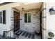 Inviting entryway with decorative stone accents, ornate iron details, and a welcoming entrance mat at 1748 W Tennessee Ave, Denver, CO 80223