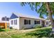 Single-story home with a manicured lawn, black shuttered windows and blue accent on side of house at 1748 W Tennessee Ave, Denver, CO 80223