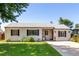 Inviting single-story home featuring a lush front lawn and well-maintained landscaping at 1748 W Tennessee Ave, Denver, CO 80223